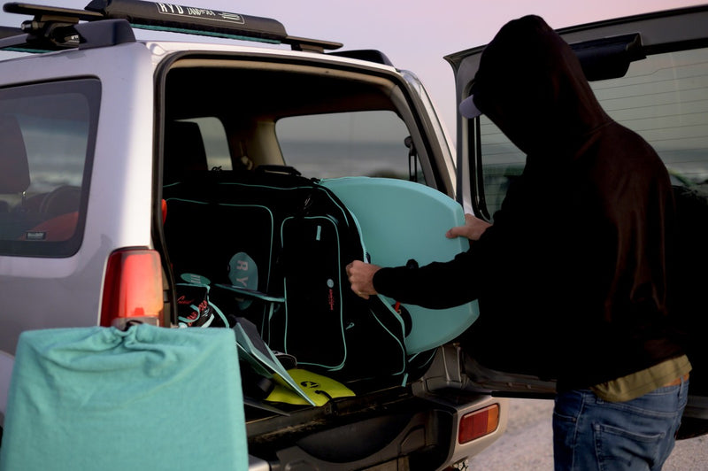 Loading a bodyboard and RYD Bodyboard Range Simple bag into a Suzuki Jimny